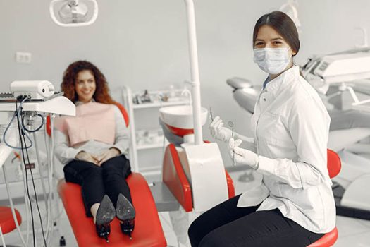 Woman in the dentist's office. Doctor in a uniform.