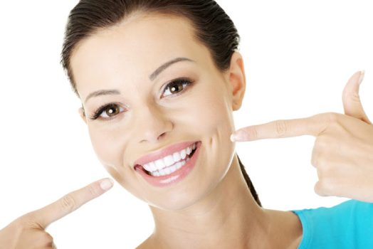 Woman showing her perfect straight white teeth.