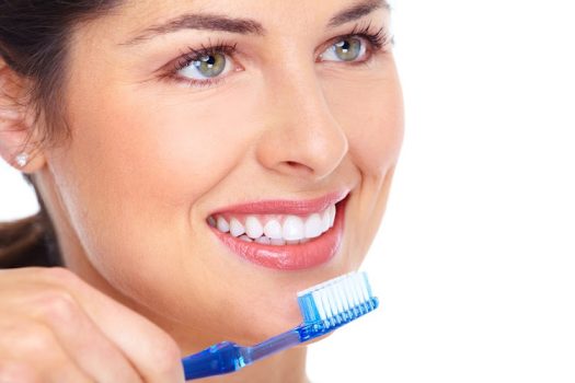 Happy woman with a toothbrush. Dental care. Isolated on white background.