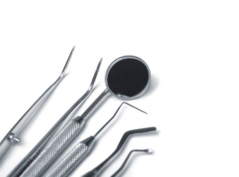 Dental instruments closeup isolated over white