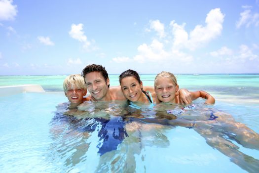 Family of four bathing in swimming pool